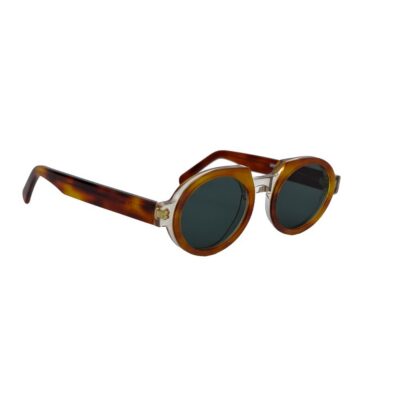 Three-quarter angle view of Seeoo Sun 05 sunglasses featuring a thick honey tortoiseshell frame, round dark lenses, and a clear bridge